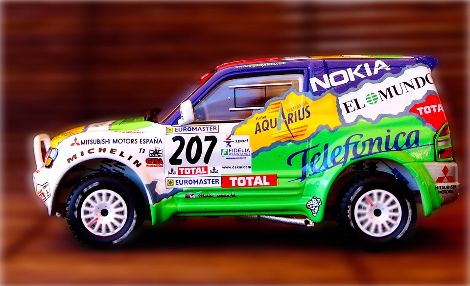 A car with stickers and names of its sponsors all over its body